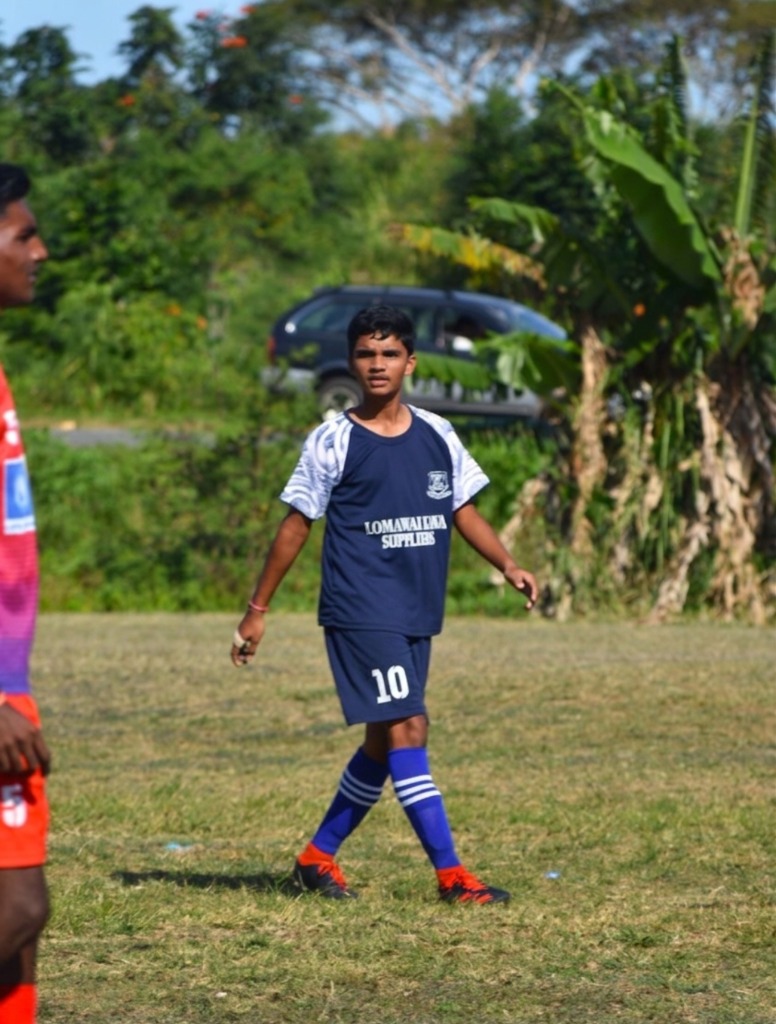 Aryan playing football on the field in jersey number 10